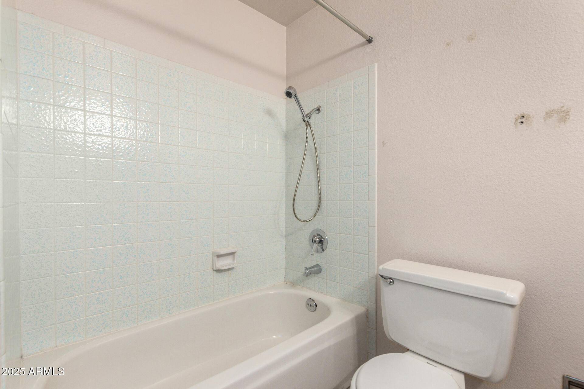 4740 West Bloomfield Road Glendale, AZ 85304 - Photo 26 of 34 a white toilet sitting next to a bath tub and shower
