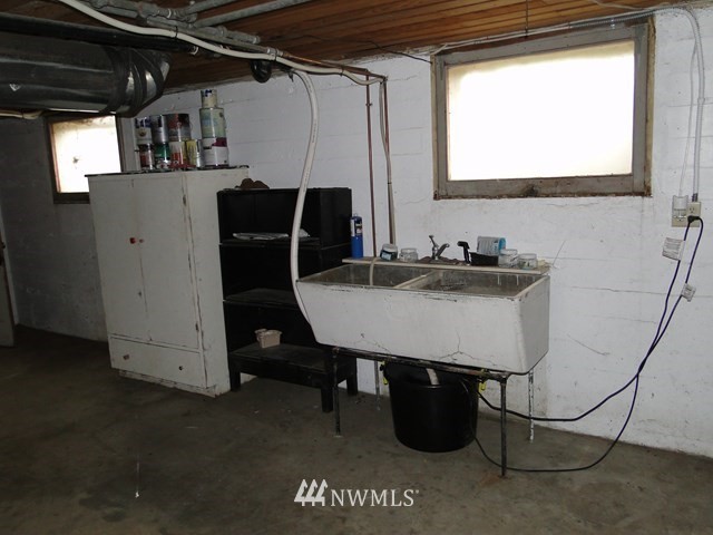 3890 Upton Road Prescott, WA 99348 - Photo 17 of 31 a room with a table chairs and a refrigerator