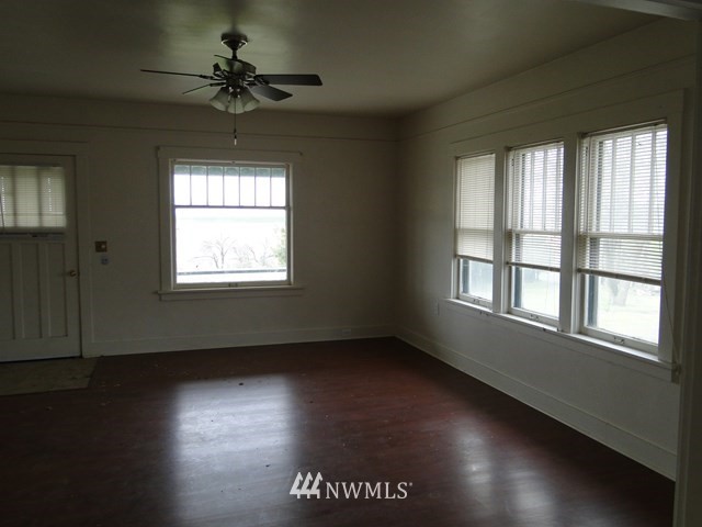 3890 Upton Road Prescott, WA 99348 - Photo 5 of 31 a view of an empty room with wooden floor and a window