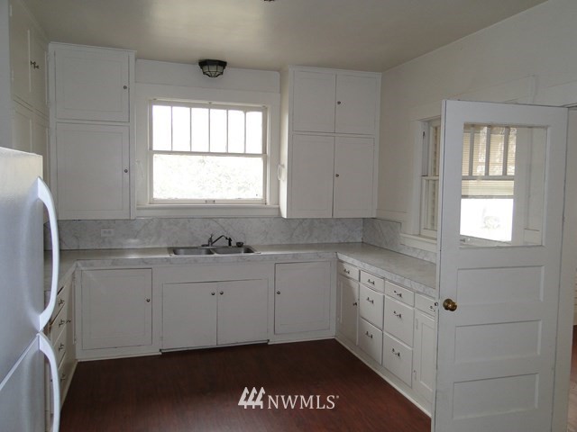 3890 Upton Road Prescott, WA 99348 - Photo 10 of 31 a kitchen with granite countertop white cabinets and a sink