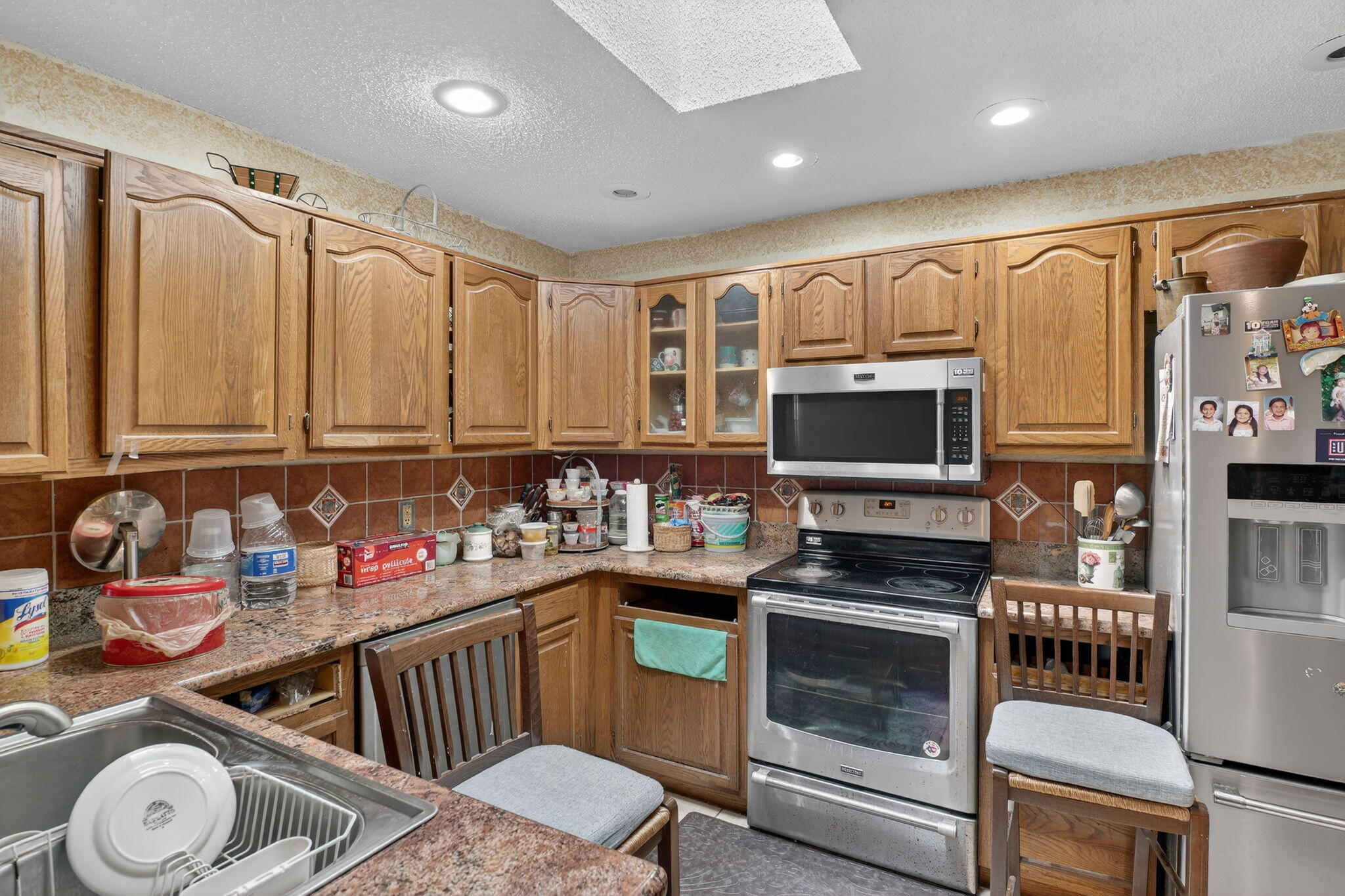 3133 Fairview Drive Melbourne, FL 32934 - Photo 18 of 45 a kitchen with granite countertop a stove a sink and a microwave