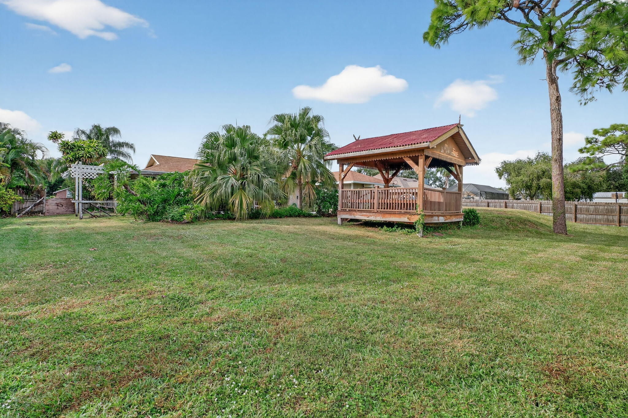 3133 Fairview Drive Melbourne, FL 32934 - Photo 41 of 45 a view of a house with a big yard and potted plants