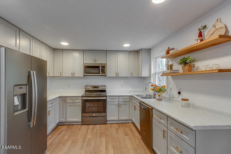 149 Alger Road Oak Ridge, TN 37830 - Photo 11 of 20 a kitchen with stainless steel appliances a refrigerator stove and sink