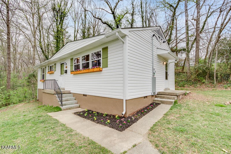 149 Alger Road Oak Ridge, TN 37830 - Photo 2 of 20 a view of a white house with a yard and sitting area