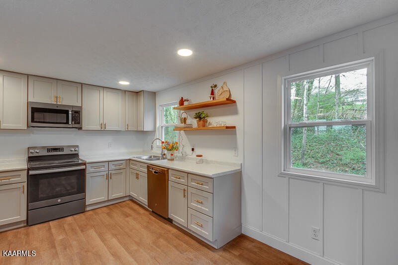 149 Alger Road Oak Ridge, TN 37830 - Photo 8 of 20 a kitchen with stainless steel appliances granite countertop a stove and a sink