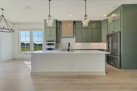 a view of a kitchen center island and stainless steel appliances
