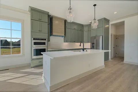 a spacious bathroom with a sink a washer and dryer