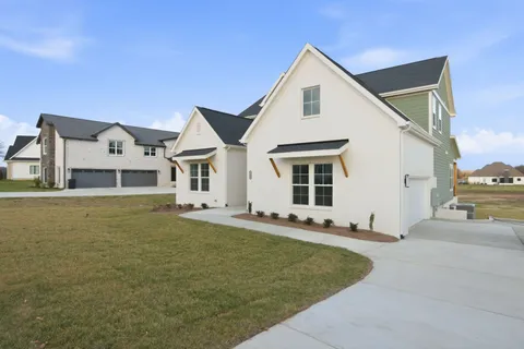 a front view of a house with a garden