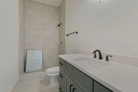 a spacious bathroom with a bathtub sink and mirror