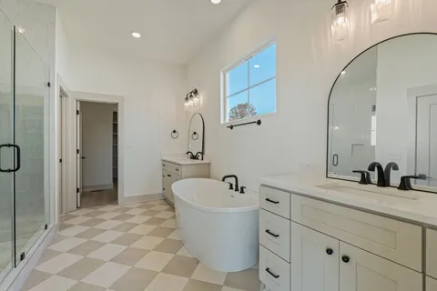 an empty room with ceiling fan and windows