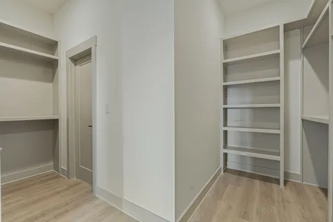 an empty room with a ceiling fan and windows