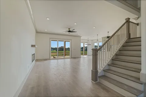 a view of entryway and hall with wooden floor