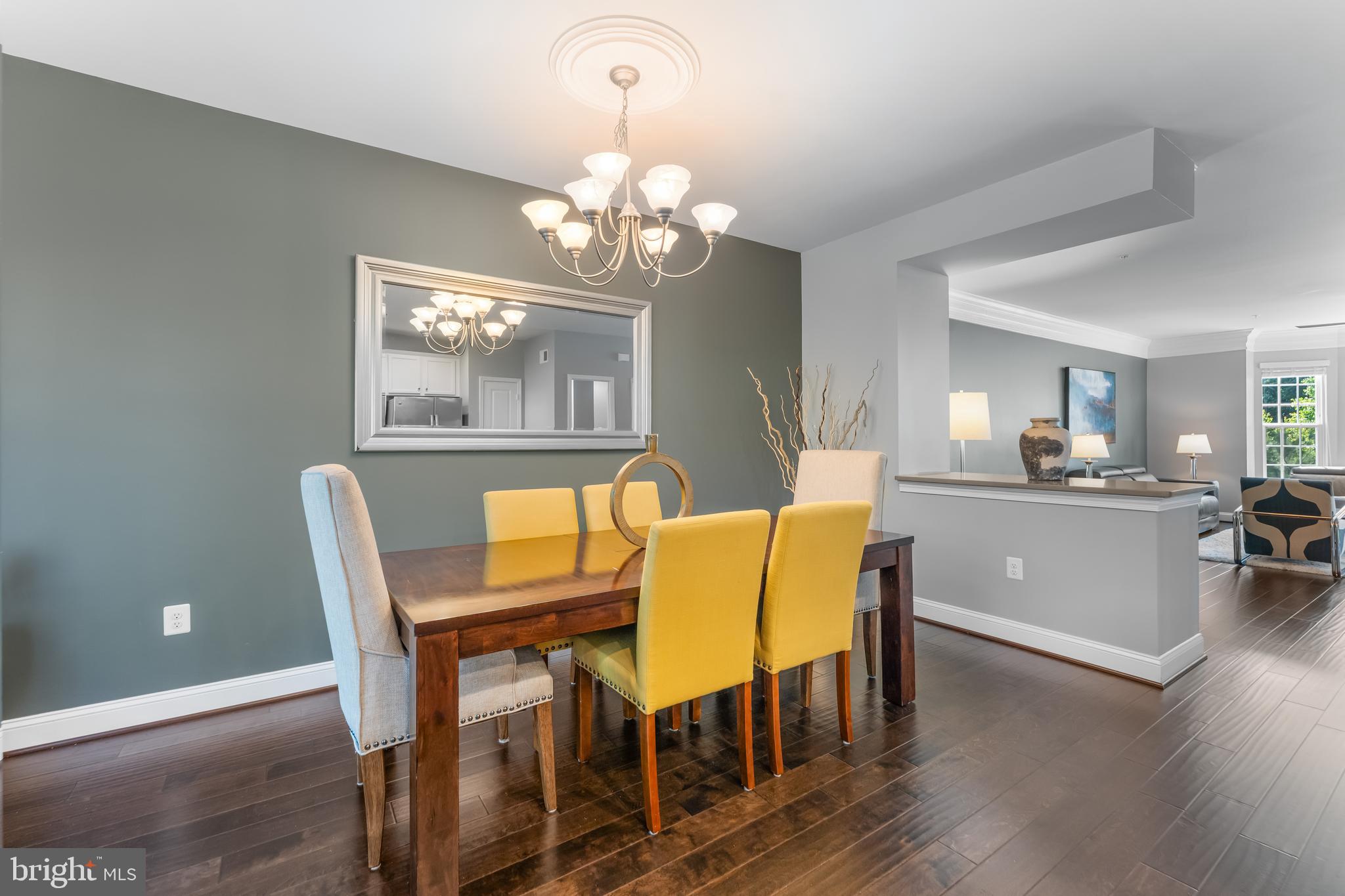 7820 Loblolly Way Hanover, MD 21076 - Photo 15 of 75 a view of a dining room with furniture a chandelier and wooden floor
