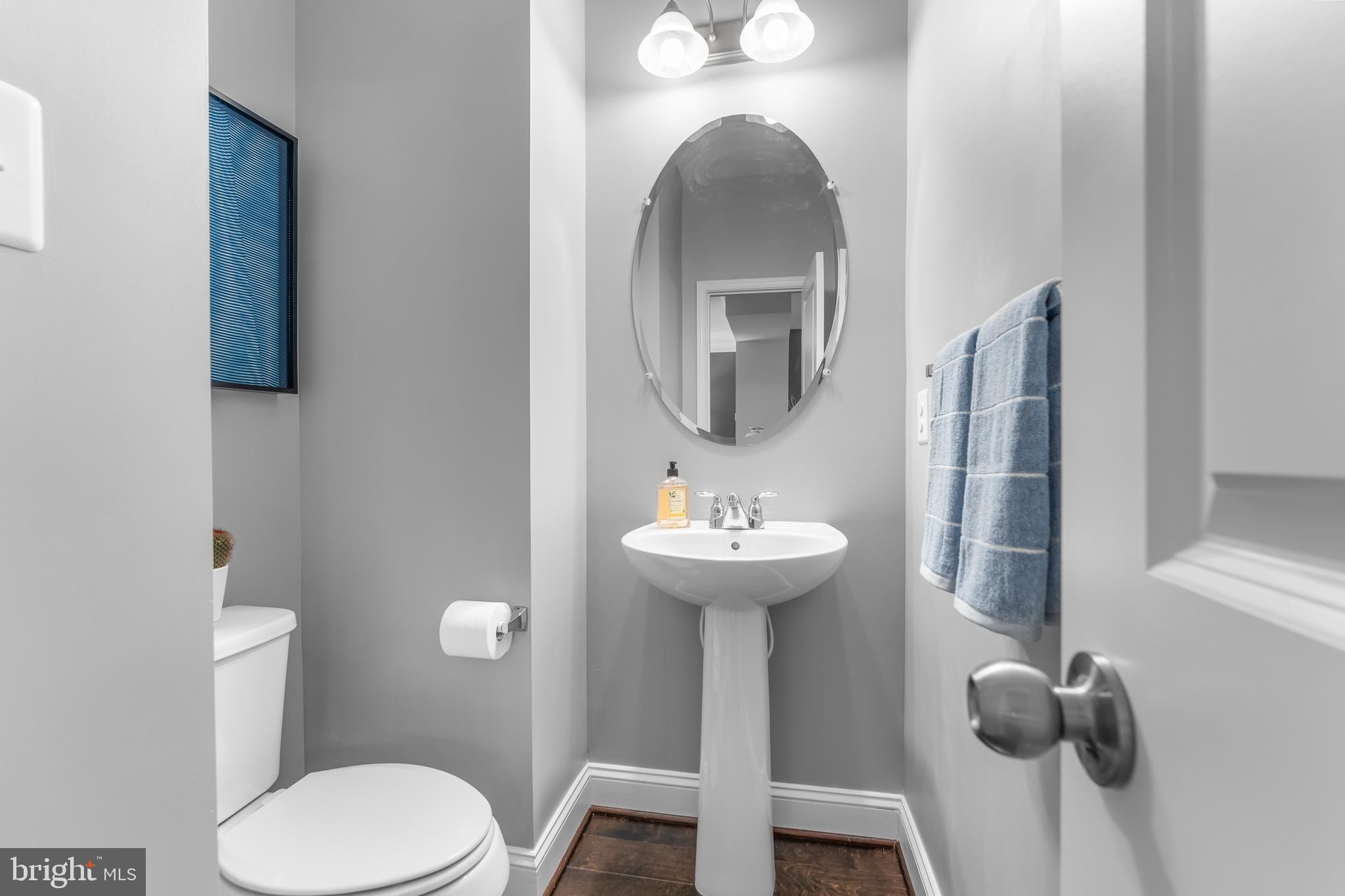 7820 Loblolly Way Hanover, MD 21076 - Photo 16 of 75 a bathroom with a toilet sink and mirror