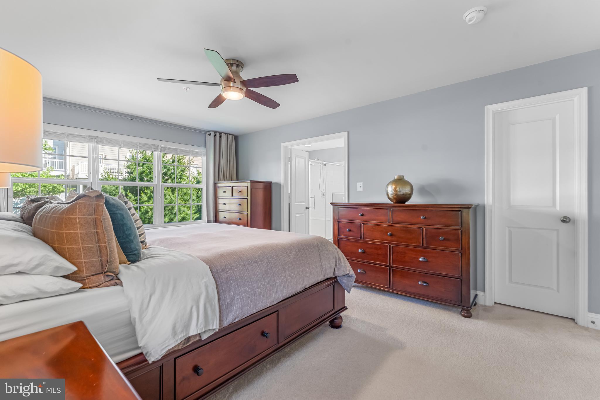 7820 Loblolly Way Hanover, MD 21076 - Photo 22 of 75 a bedroom with a bed and large windows