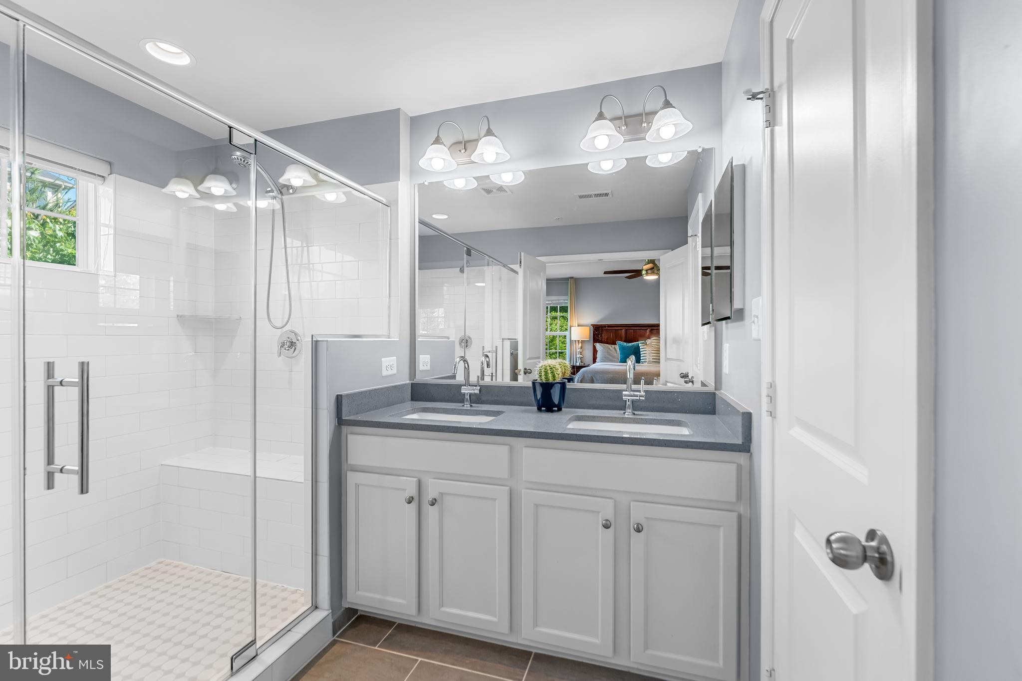 7820 Loblolly Way Hanover, MD 21076 - Photo 25 of 75 a bathroom with a double vanity sink and a mirror