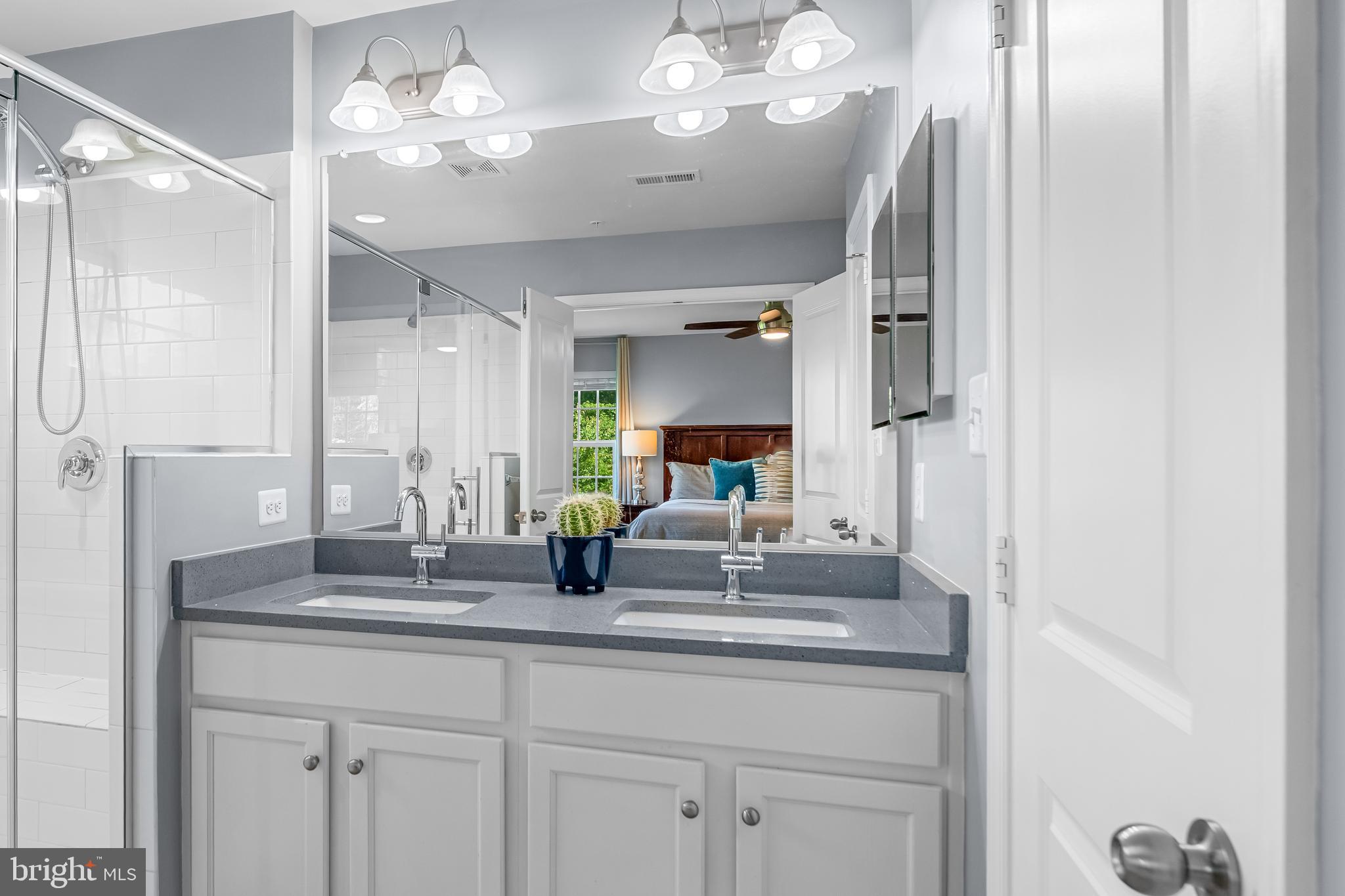 7820 Loblolly Way Hanover, MD 21076 - Photo 26 of 75 a bathroom with a granite countertop sink a light fixture and a mirror