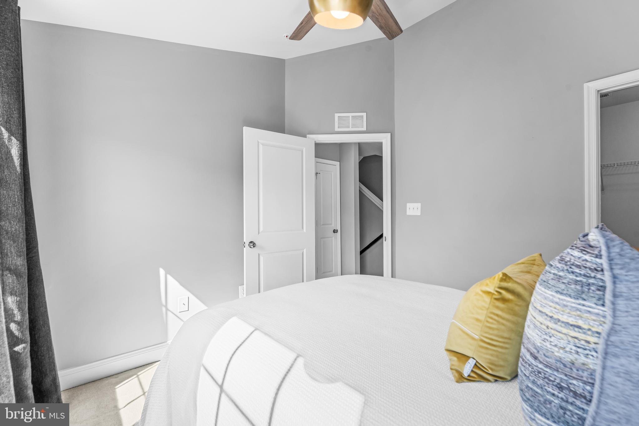 7820 Loblolly Way Hanover, MD 21076 - Photo 35 of 75 a bedroom with a bed and a chandelier