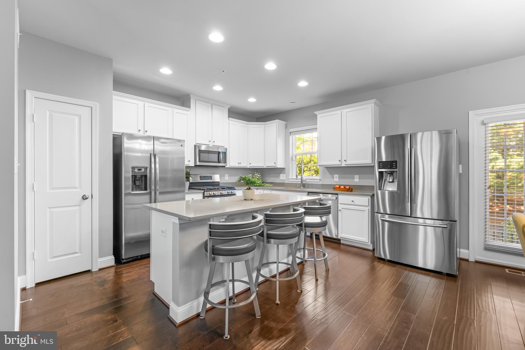 7820 Loblolly Way Hanover, MD 21076 - Photo 4 of 75 a kitchen with a refrigerator a microwave and wooden floor