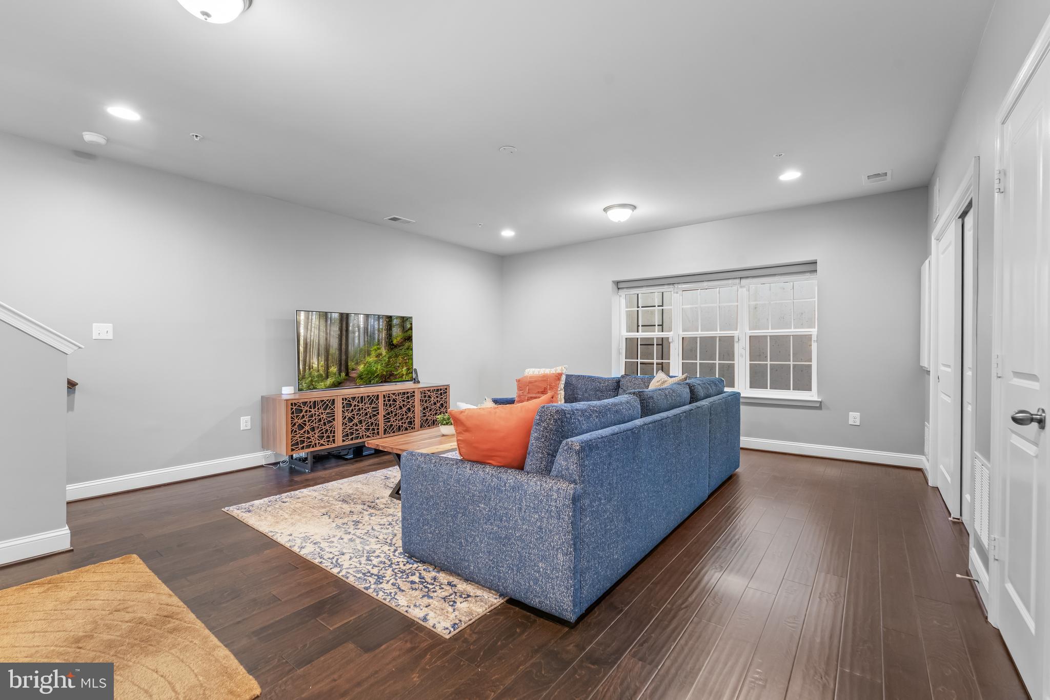 7820 Loblolly Way Hanover, MD 21076 - Photo 45 of 75 a living room with furniture and a wooden floor