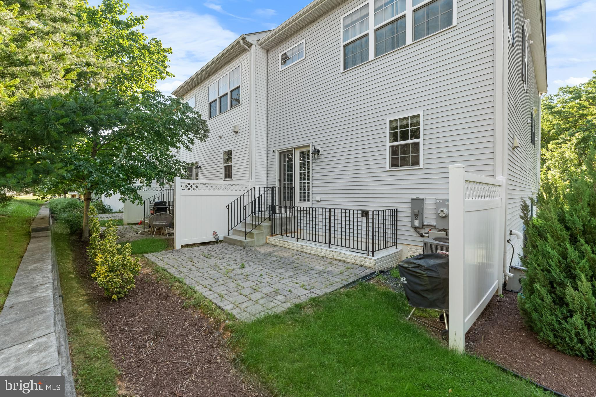 7820 Loblolly Way Hanover, MD 21076 - Photo 54 of 75 a view of a house with a yard and table and chair under an umbrella