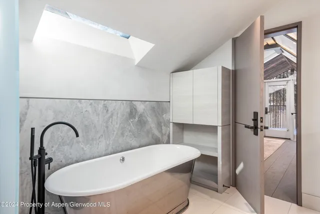 a bath tub sitting next to a bathroom sink