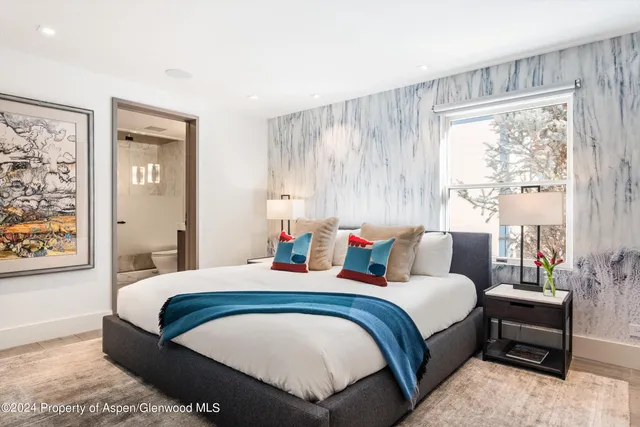 a bedroom with bed and a window