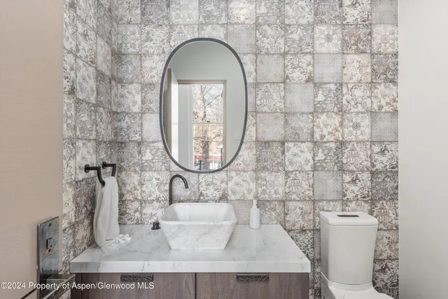 a bathroom with a sink a mirror and a shower