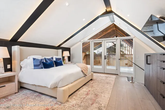 a bedroom with a bed and a large window