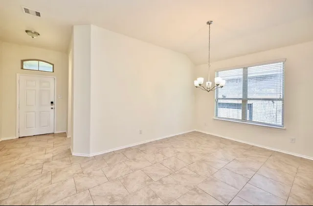 a view of an empty room with a window