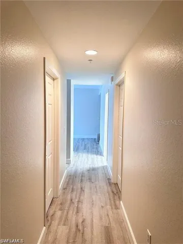 a view of a room with wooden floor