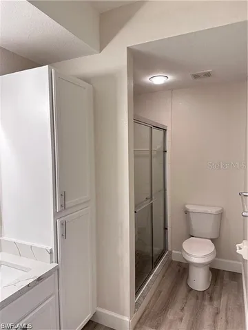 a bathroom with a toilet and a shower