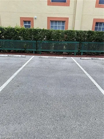 a view of a yard with plants and trees