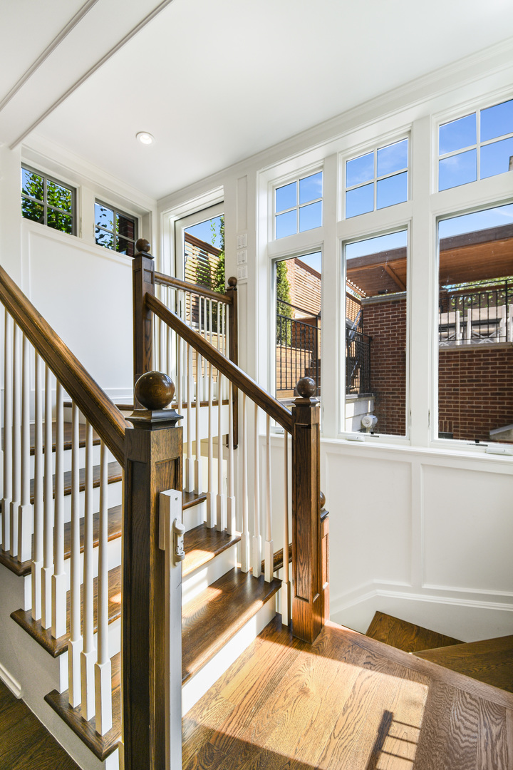 3751 North Greenview Avenue Chicago, IL 60613 - Photo 14 of 52 a view of staircase with lots of windows and white walls