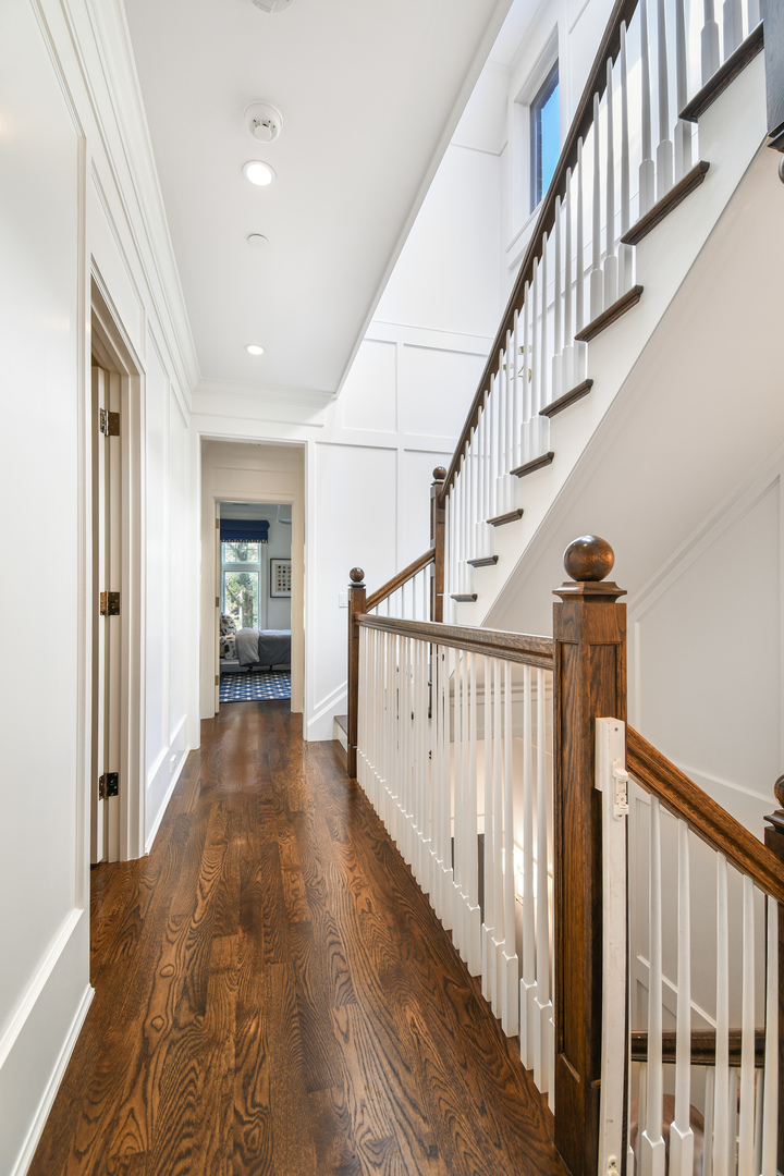 3751 North Greenview Avenue Chicago, IL 60613 - Photo 19 of 52 a view of staircase with wooden floor and a chandelier