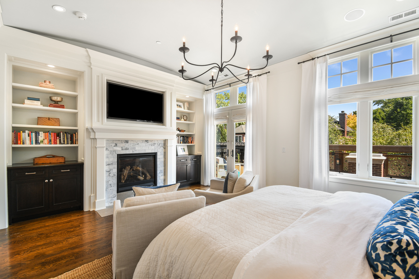 3751 North Greenview Avenue Chicago, IL 60613 - Photo 20 of 52 a bedroom with a large bed and a flat screen tv