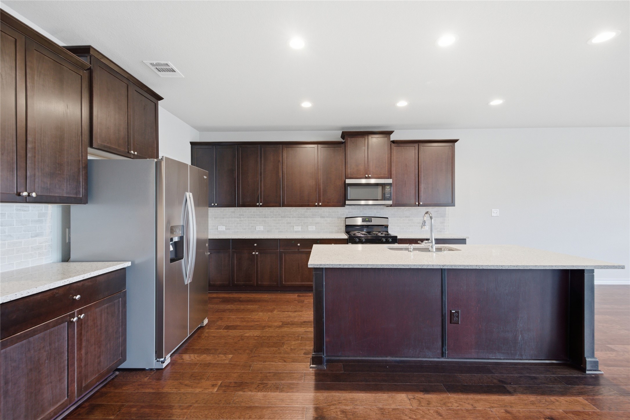 6764 Catania Loop Round Rock, TX 78665 - Photo 11 of 33 a kitchen with stainless steel appliances granite countertop wooden cabinets a sink and a stove