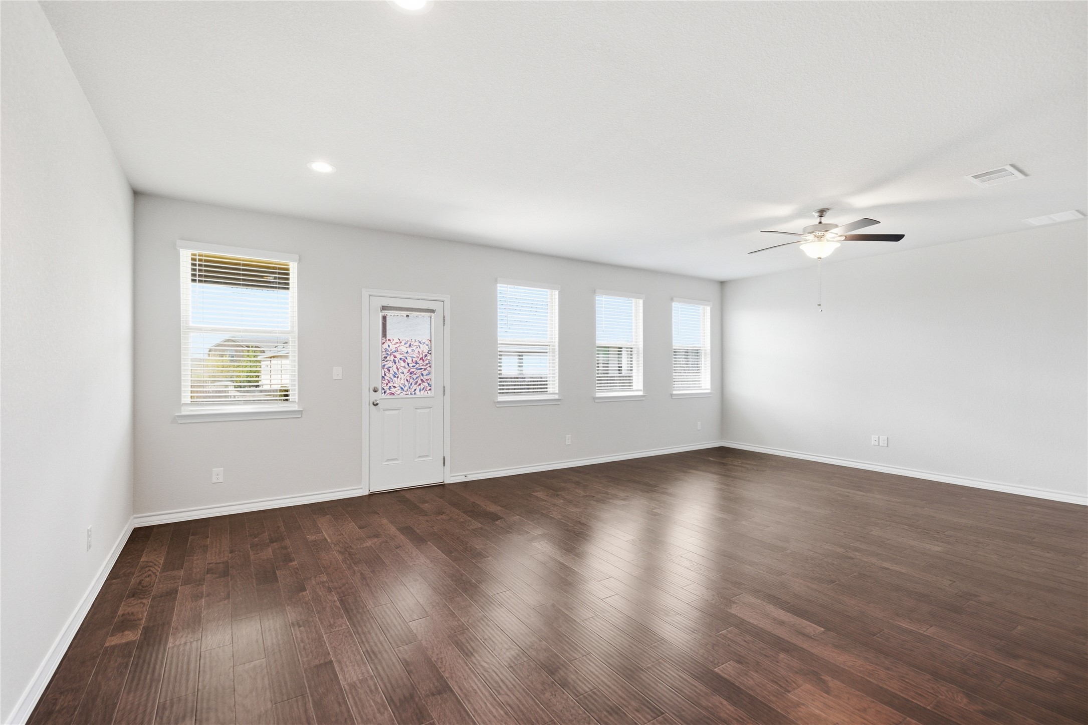 6764 Catania Loop Round Rock, TX 78665 - Photo 15 of 33 a view of an empty room with a window and wooden floor