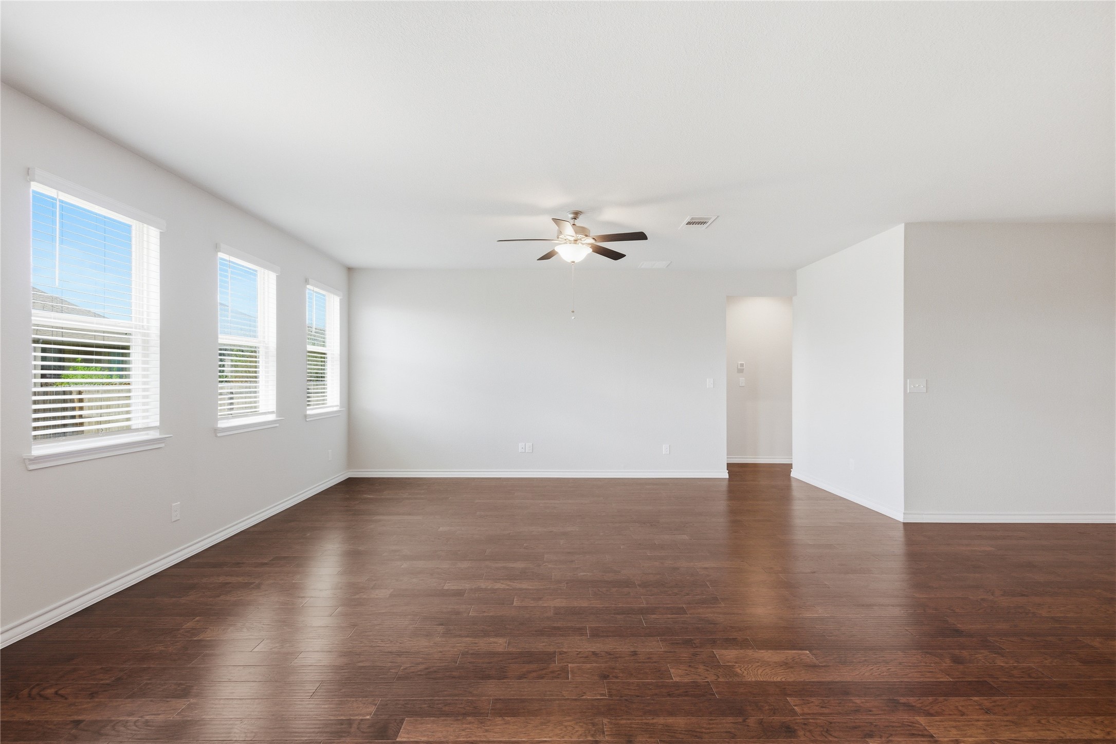 6764 Catania Loop Round Rock, TX 78665 - Photo 16 of 33 a view of an empty room with wooden floor and a window