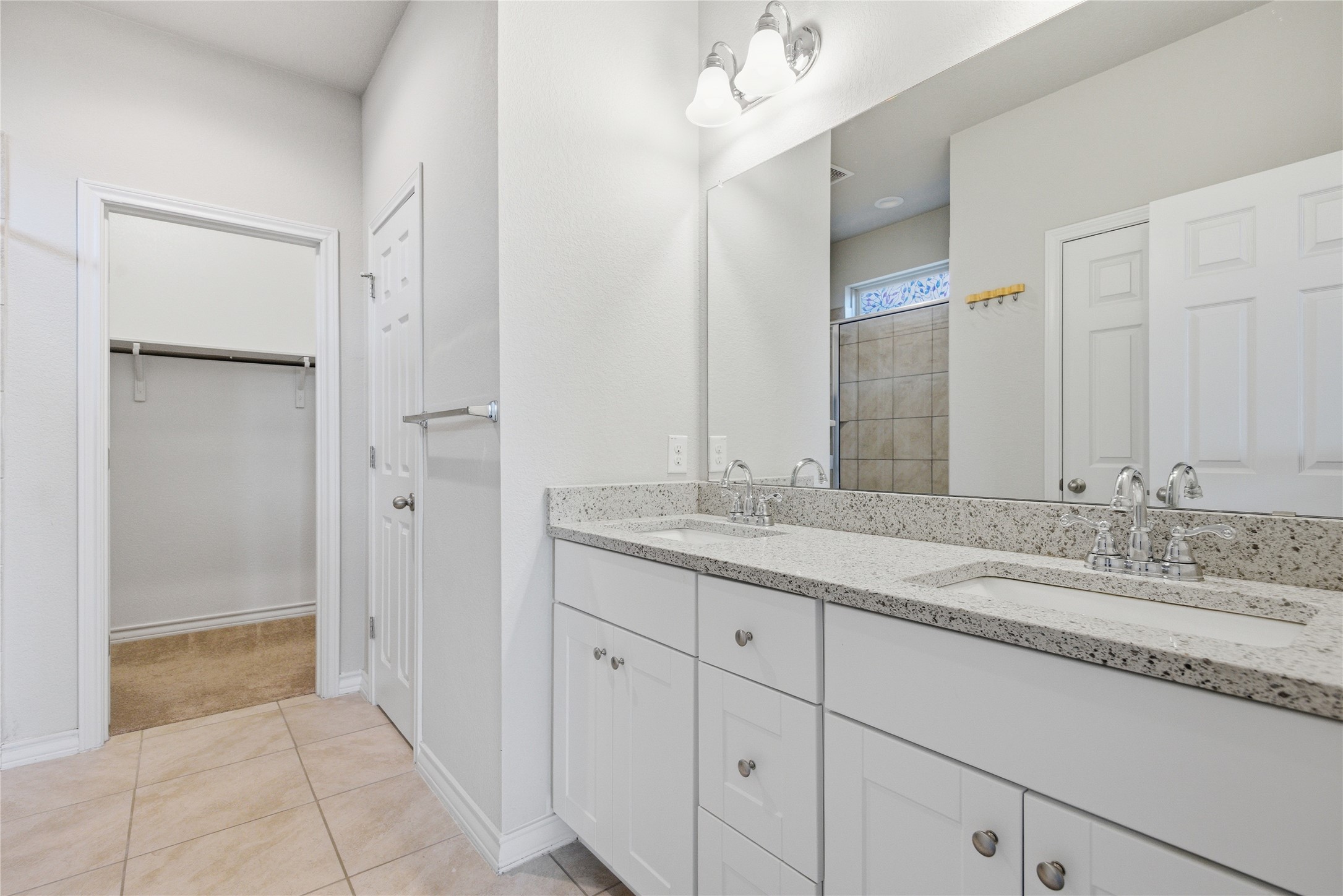 6764 Catania Loop Round Rock, TX 78665 - Photo 23 of 33 a bathroom with a granite countertop sink and a mirror