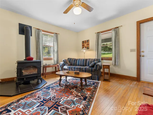 a living room with furniture a window and a flat screen tv