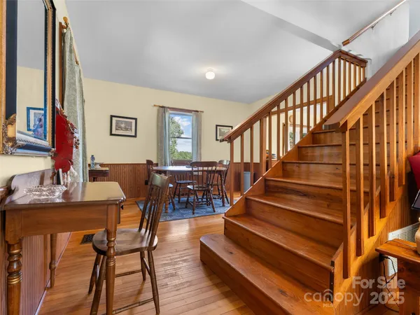 a view of entryway and hall with wooden floor