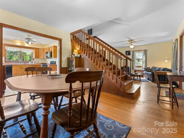 a living room with dining room and wooden floor