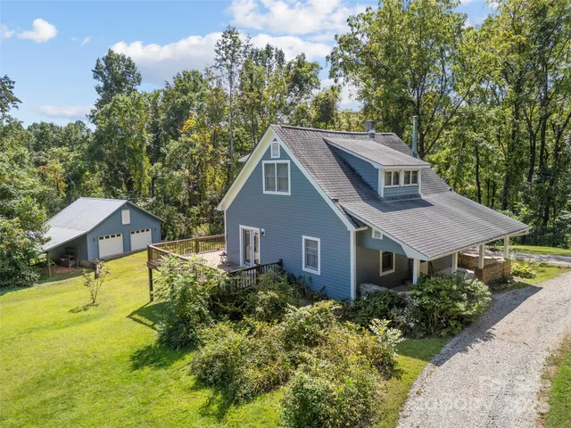 a aerial view of a house with swimming pool next to a yard