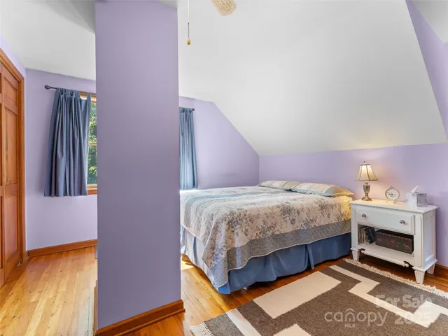 a bedroom with a bed and a fireplace