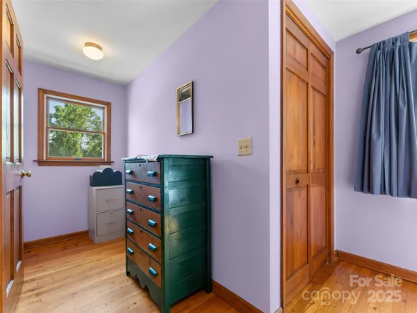 a view of a bedroom with furniture and windows