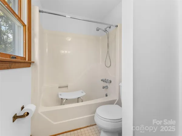 a bathroom with a toilet and a bathtub