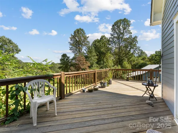 a view of a balcony with wooden floor and fence