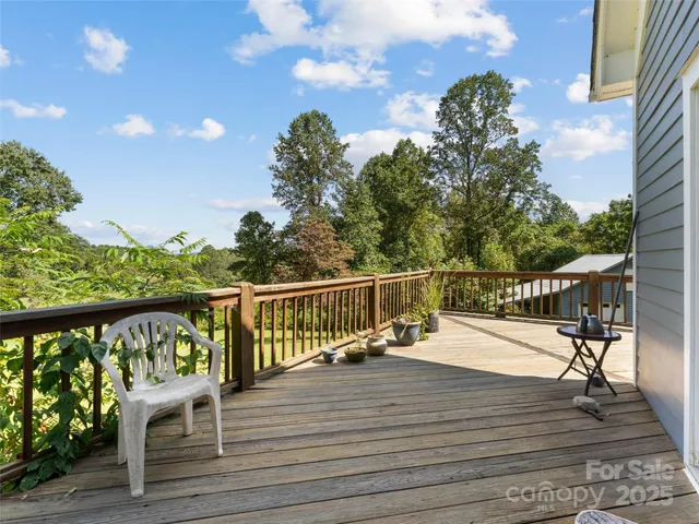 a view of a balcony with wooden floor and fence