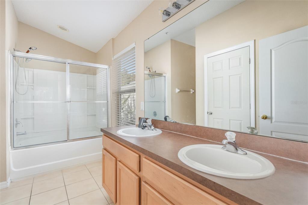 6686 South Goldenrod Road, Unit 139A Orlando, FL 32822 - Photo 14 of 23 a bathroom with a sink a mirror and a bathtub